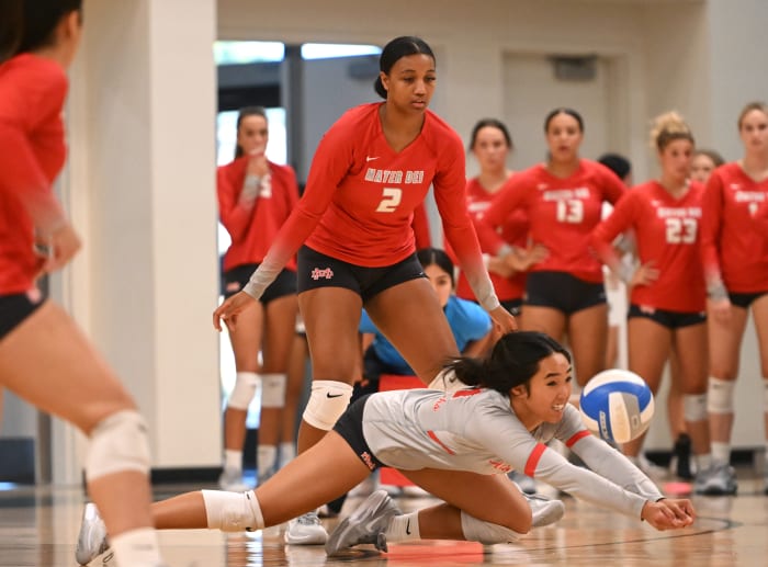 Mater Dei senior, Stanford-bound libero Malyssa Cawa dives for ball while Isabel Clark (2) looks on